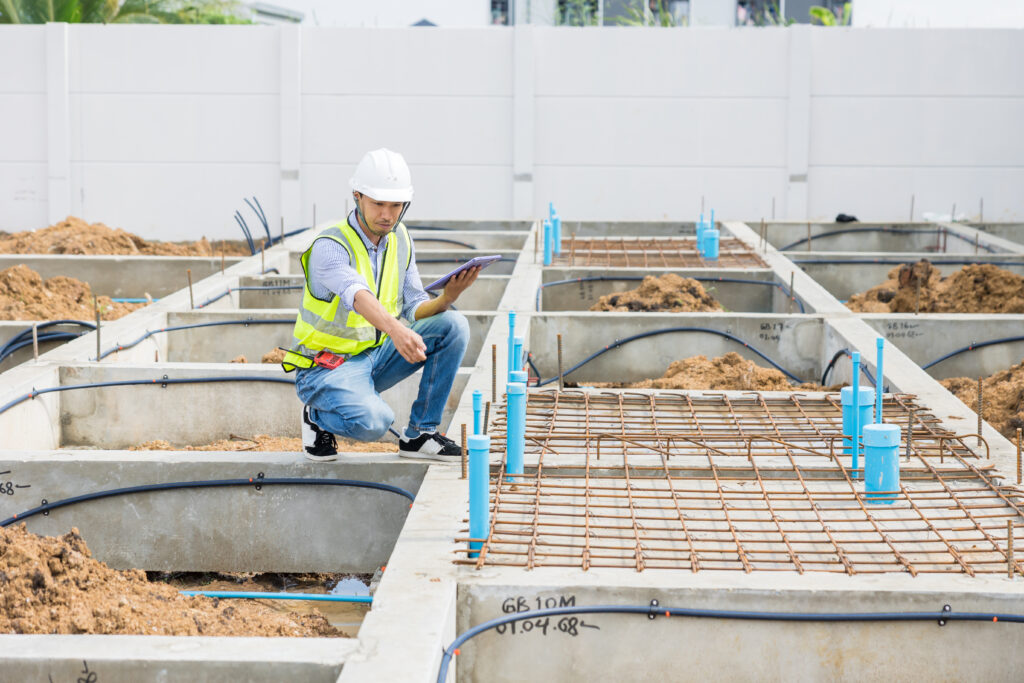 asian construction engineer, japanese builder worker male working inspecting footing house building.