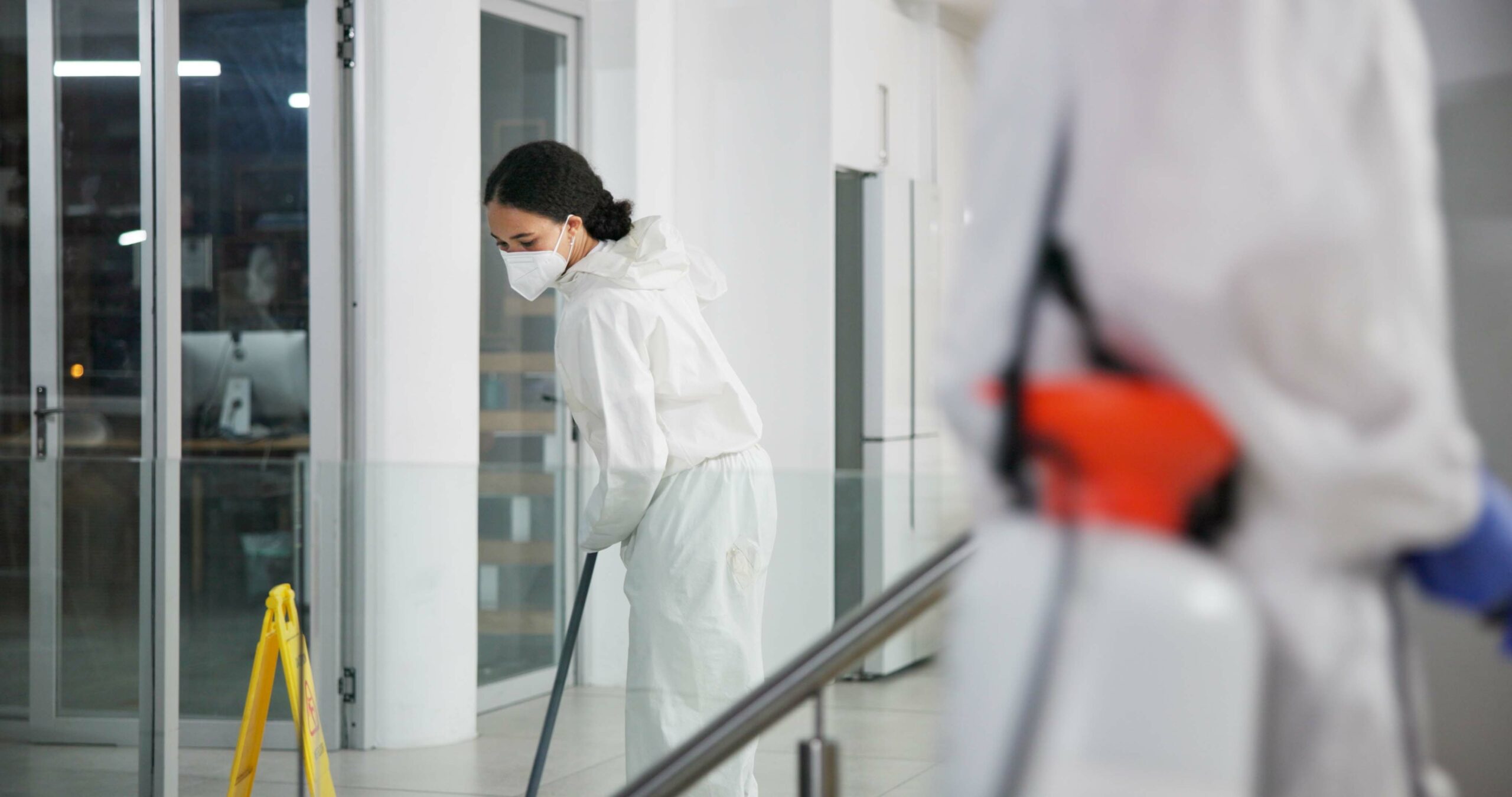 woman, cleaner and mopping for hygiene, fresh and disinfectant for virus protection or housekeeping. people, worker and ppe suit for bacteria, disease and prevention in office as janitor for company