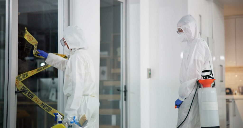 worker, team and barrier tape for forensic, evidence or cleanup for investigation or restoration. people, ppe suit and crime scene with cleaning, restricted area or office as specialist for biohazard