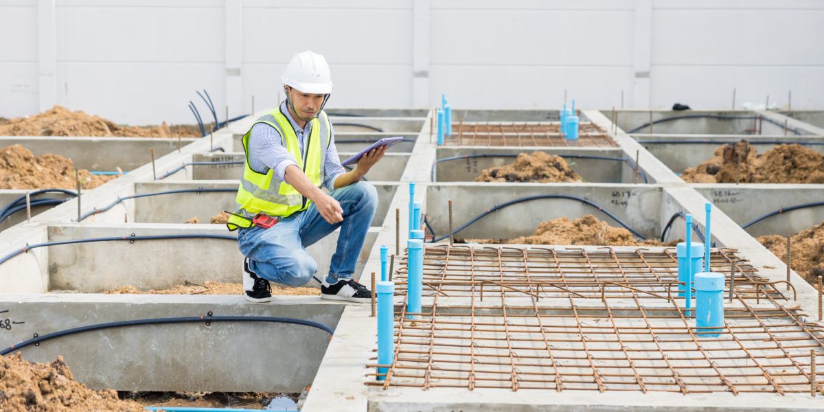 asian construction engineer, japanese builder worker male working inspecting footing house building.